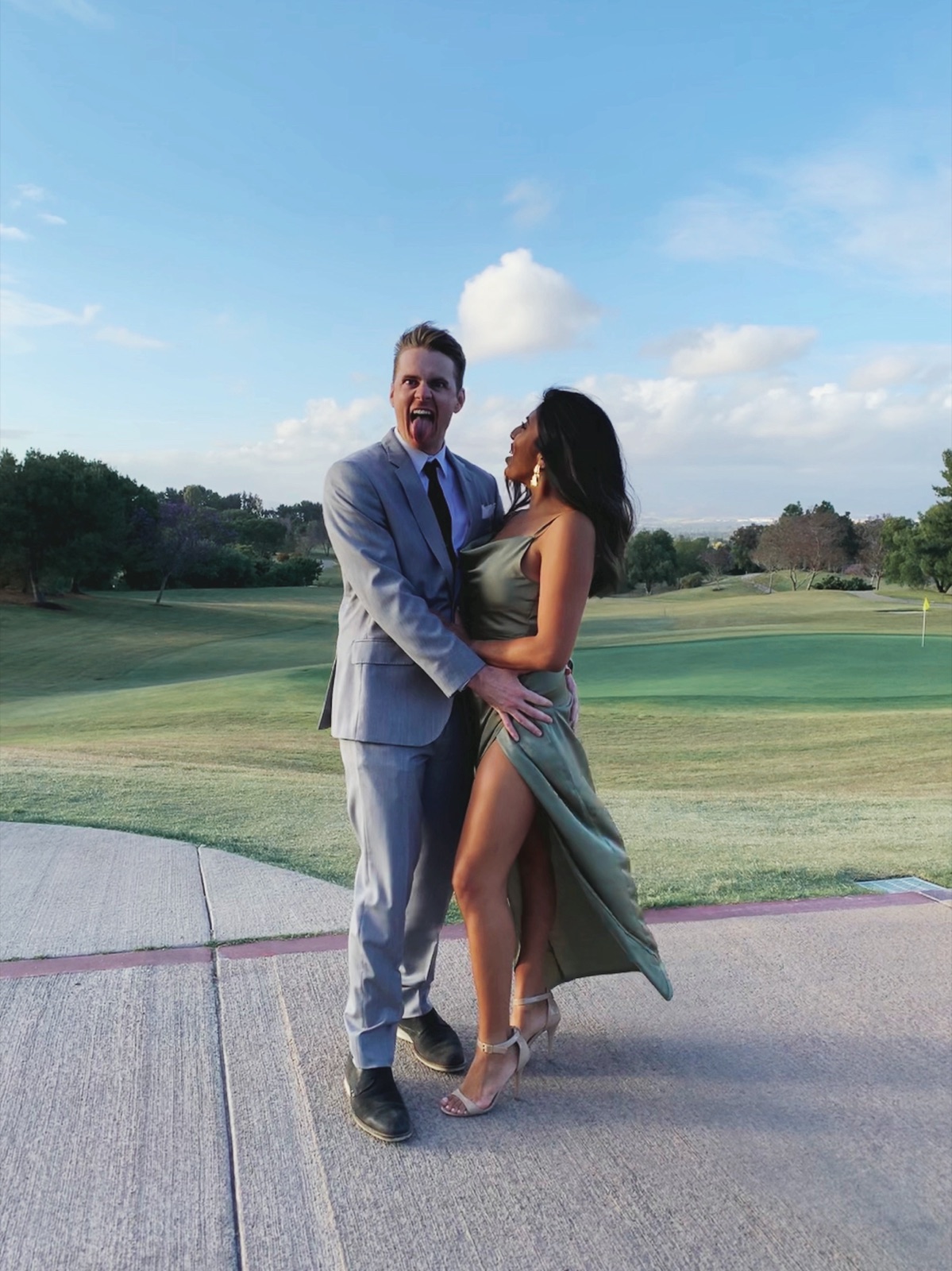 Dressed up and laughing on a golf course