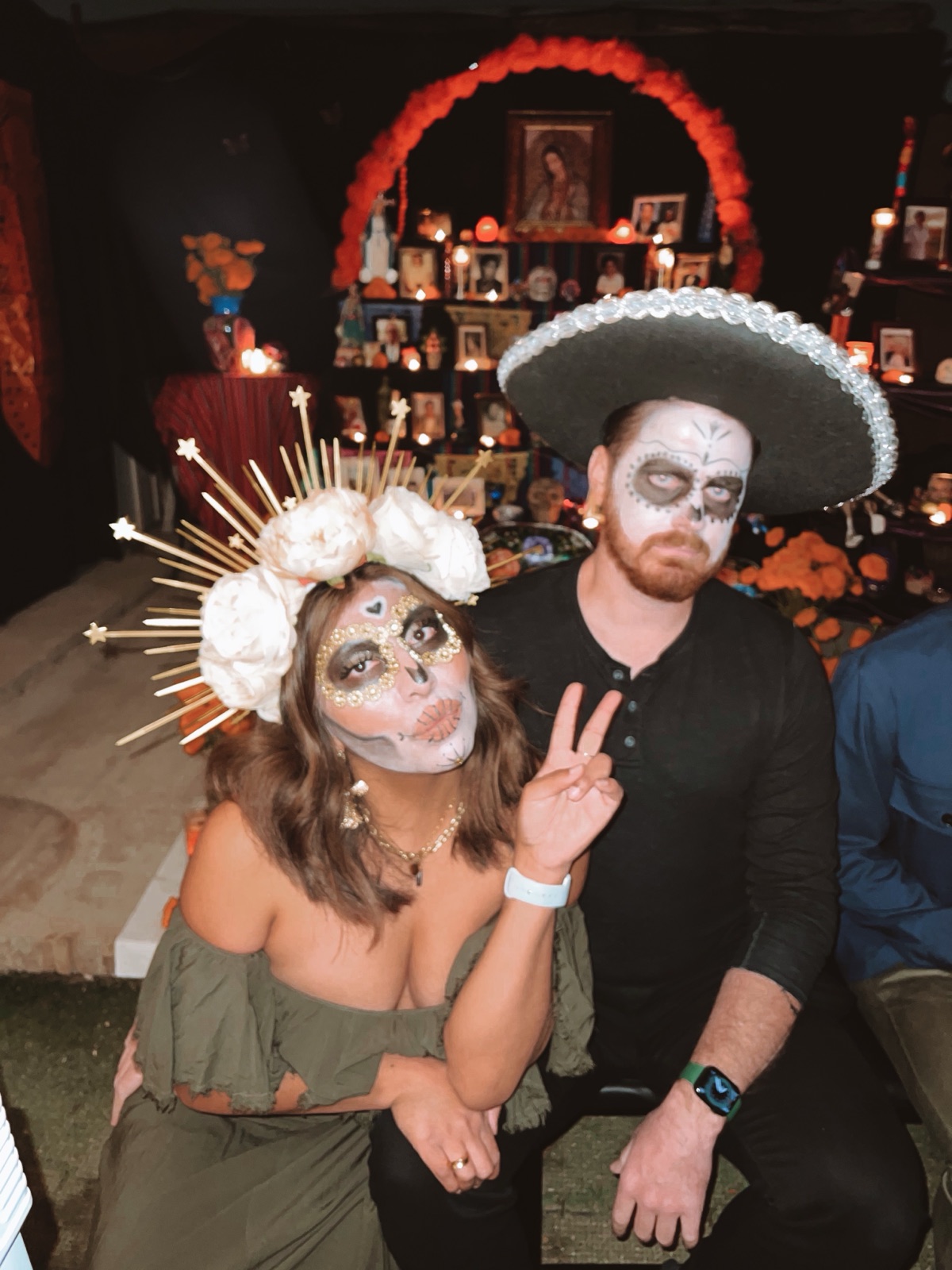 Día de Muertos face paint in front of the ofrenda